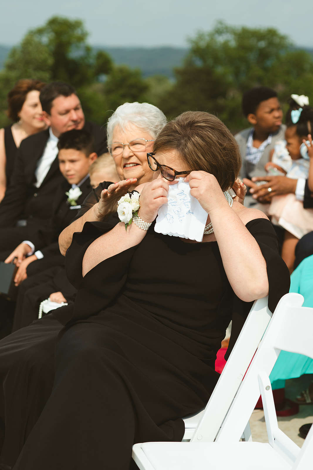 Candid wedding photo of wedding guests crying during the ceremony