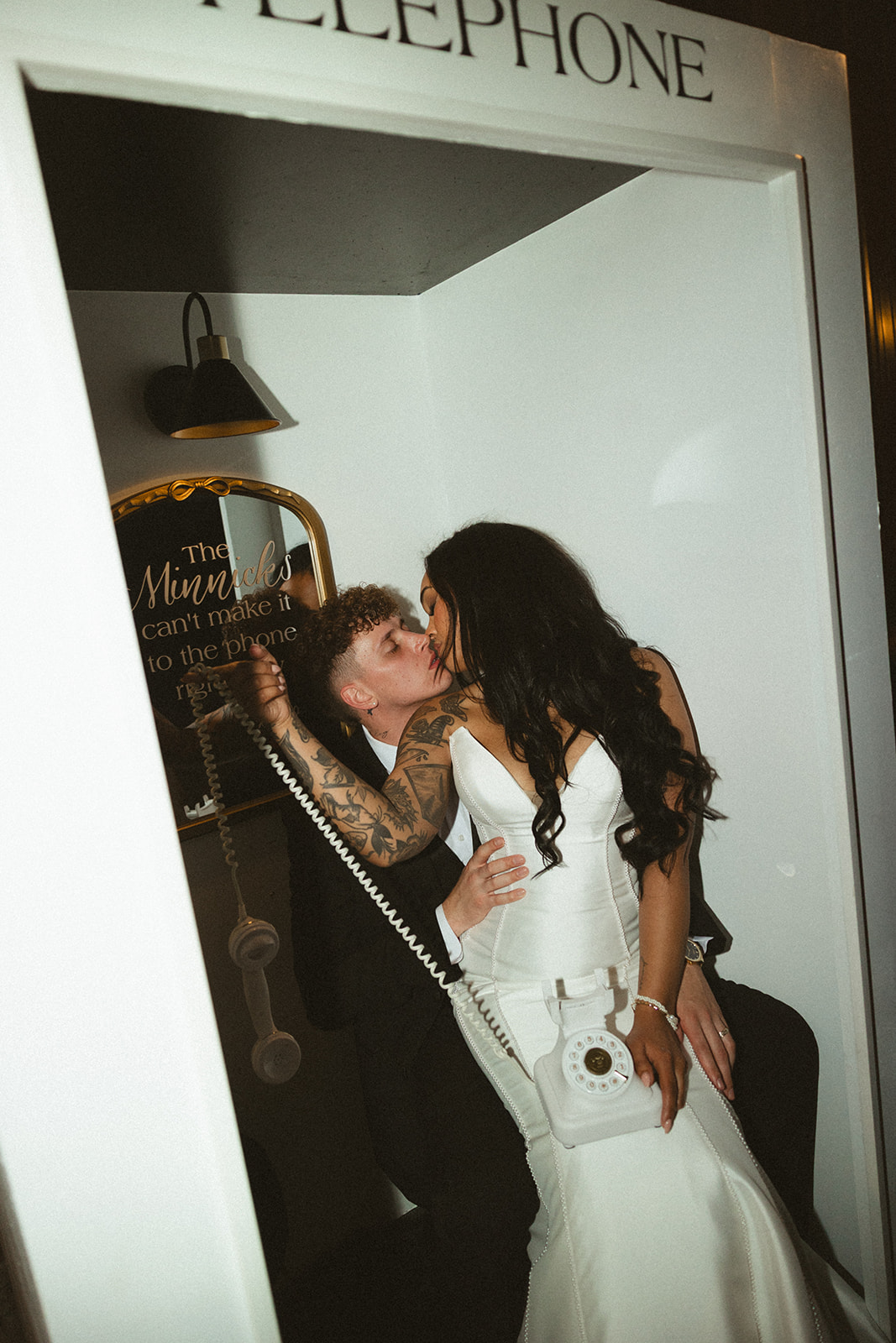 Bride and groom kissing in a wedding phone booth guestbook
