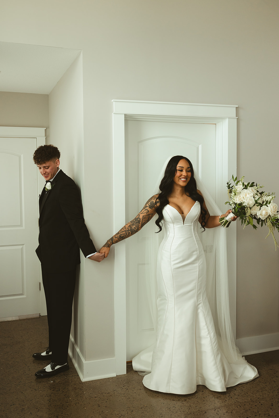 Bride and groom sharing a first touch before their wedding ceremony