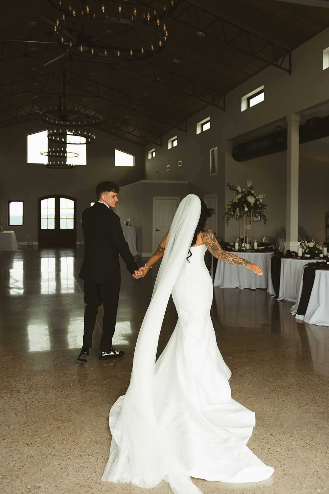 Bride and groom walking into their reception space inside of the Loyston