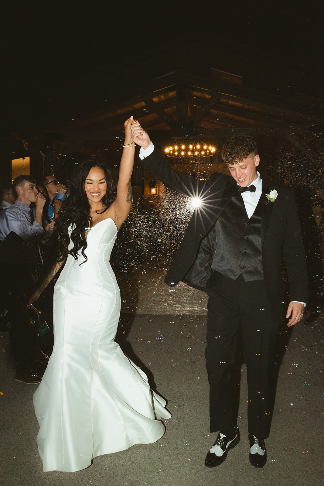 Bride and groom cheering during their bubble wedding sendoff