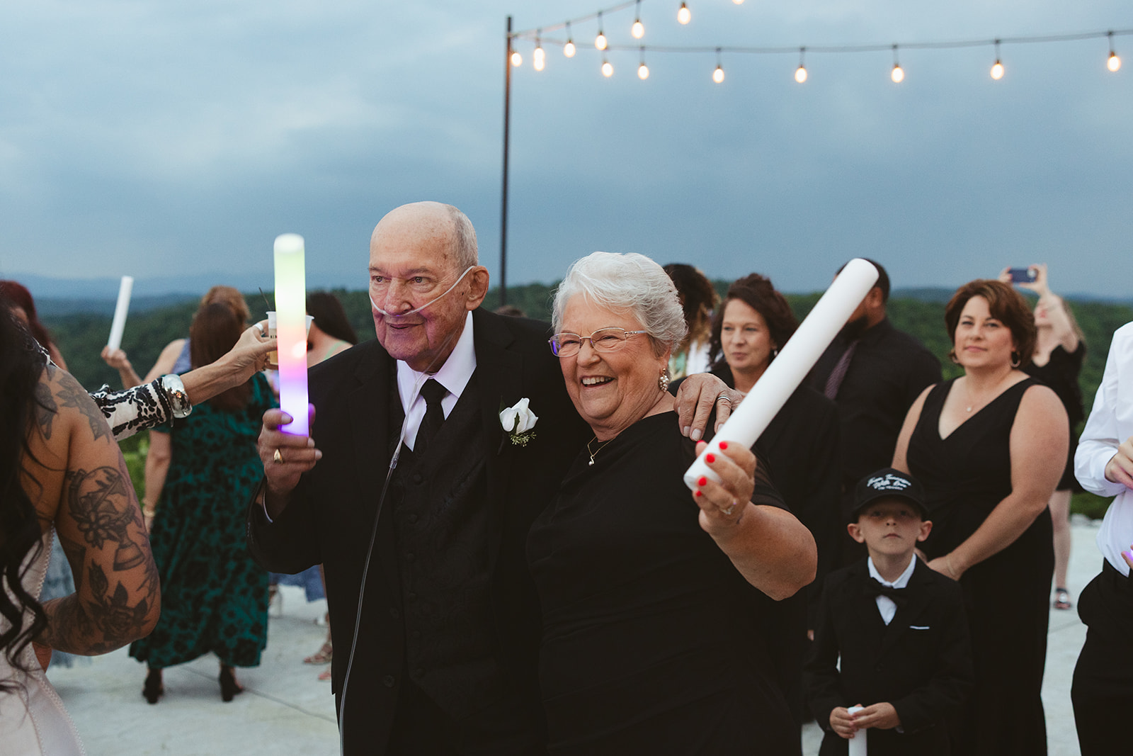 Bride's grandparents dancing with foam glow sticks at wedding reception