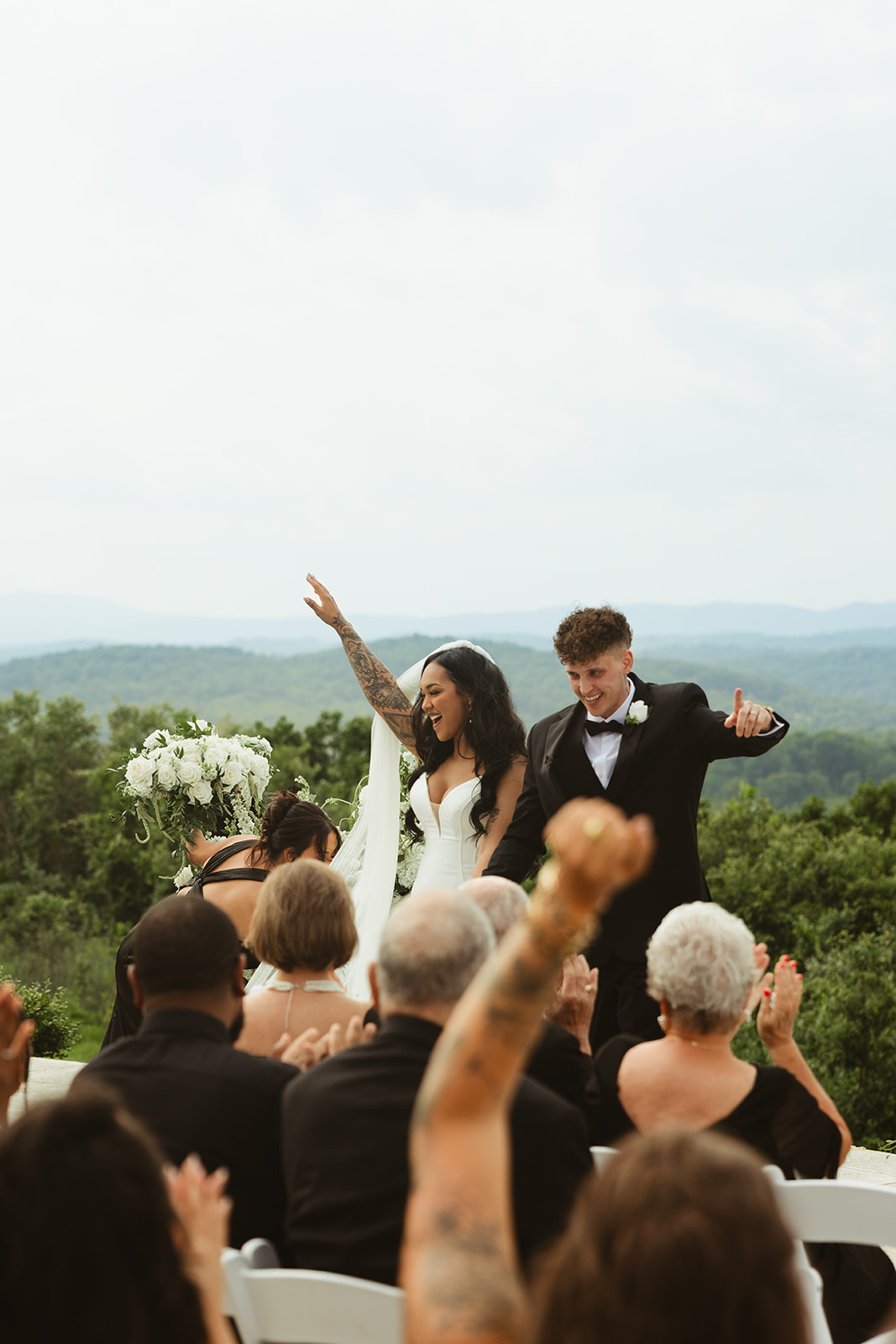 Bride and groom cheering after their wedding ceremony