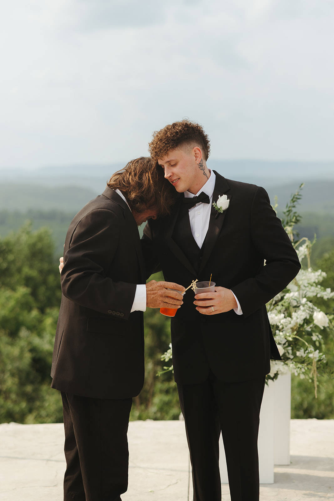Groom and groomsman hugging