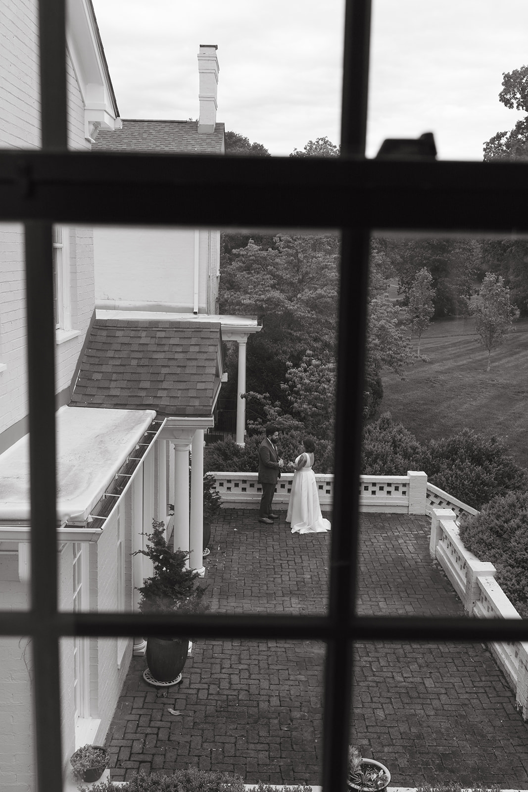 An aerial view of a bride and groom on the patio at Maple Grove Estate for a private first look