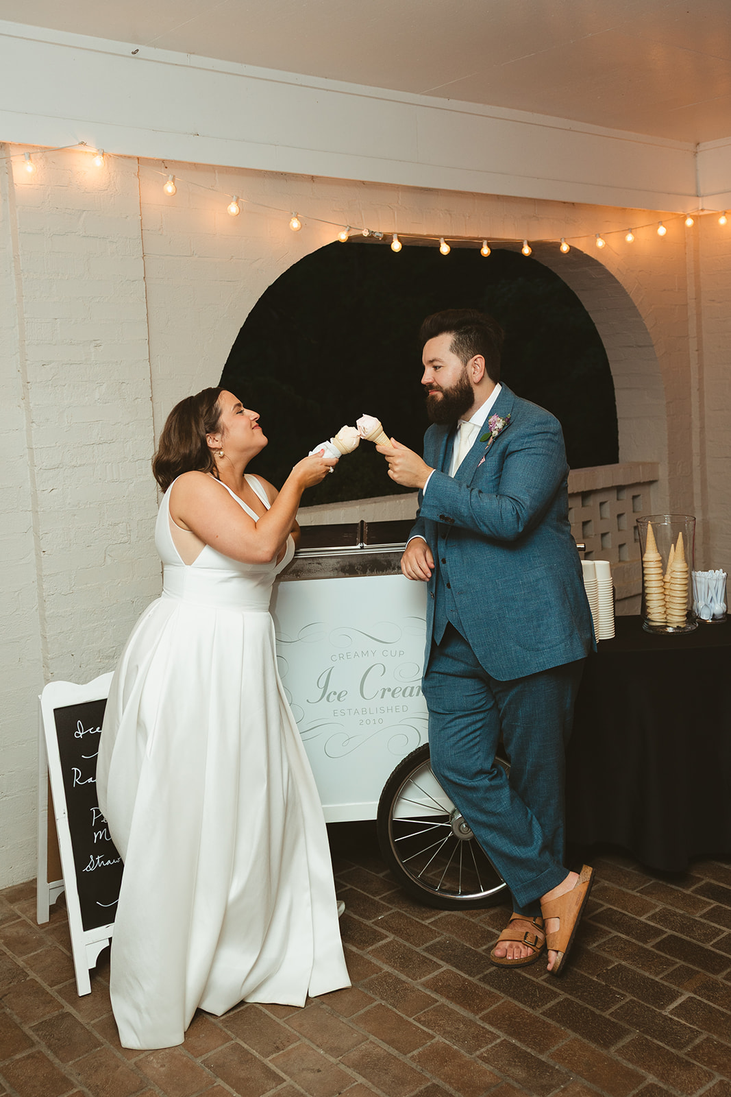 A couple "cheers"ing ice cream cones instead of a cake cutting, a great colorful wedding idea