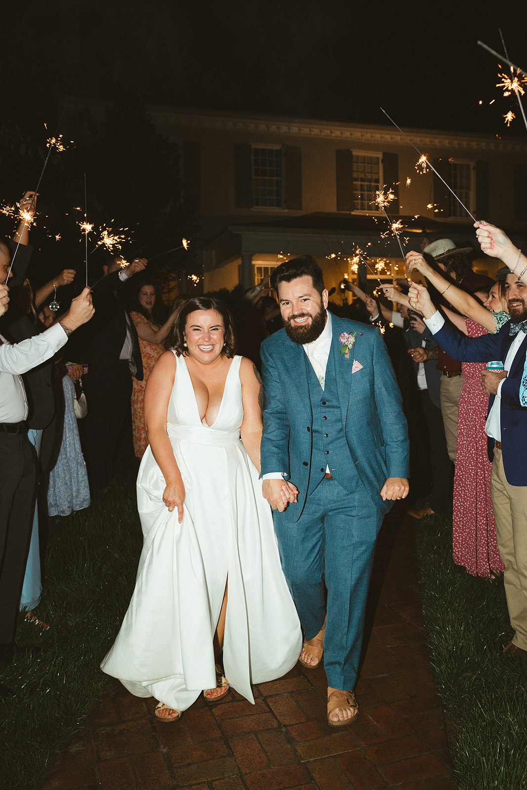 A couple walking through their sparkler exit