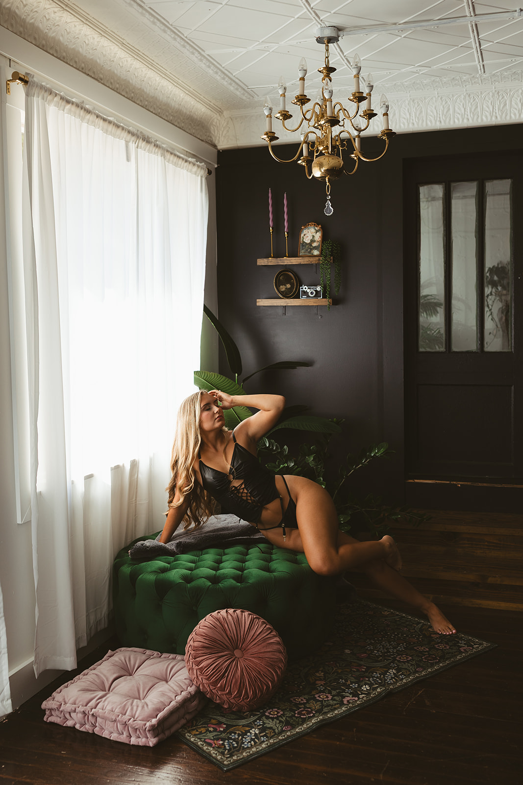 A girl posing on a chair for her boudoir photos