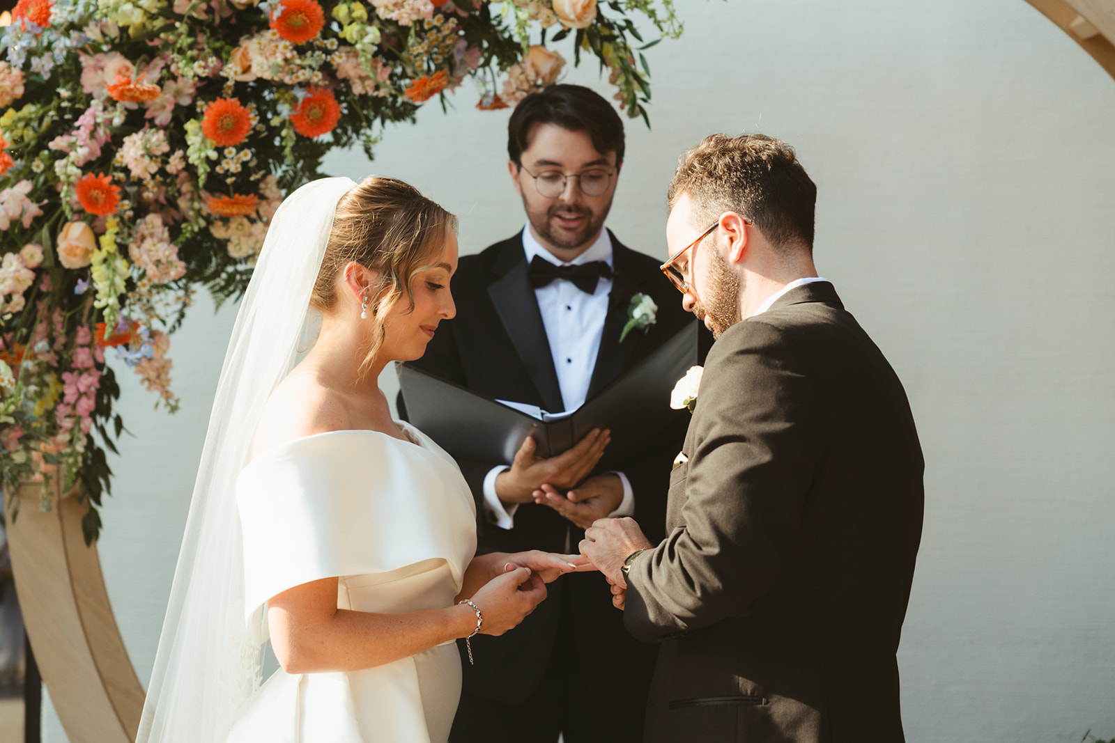 Documentary style wedding photography of a bride and groom exchanging rings
