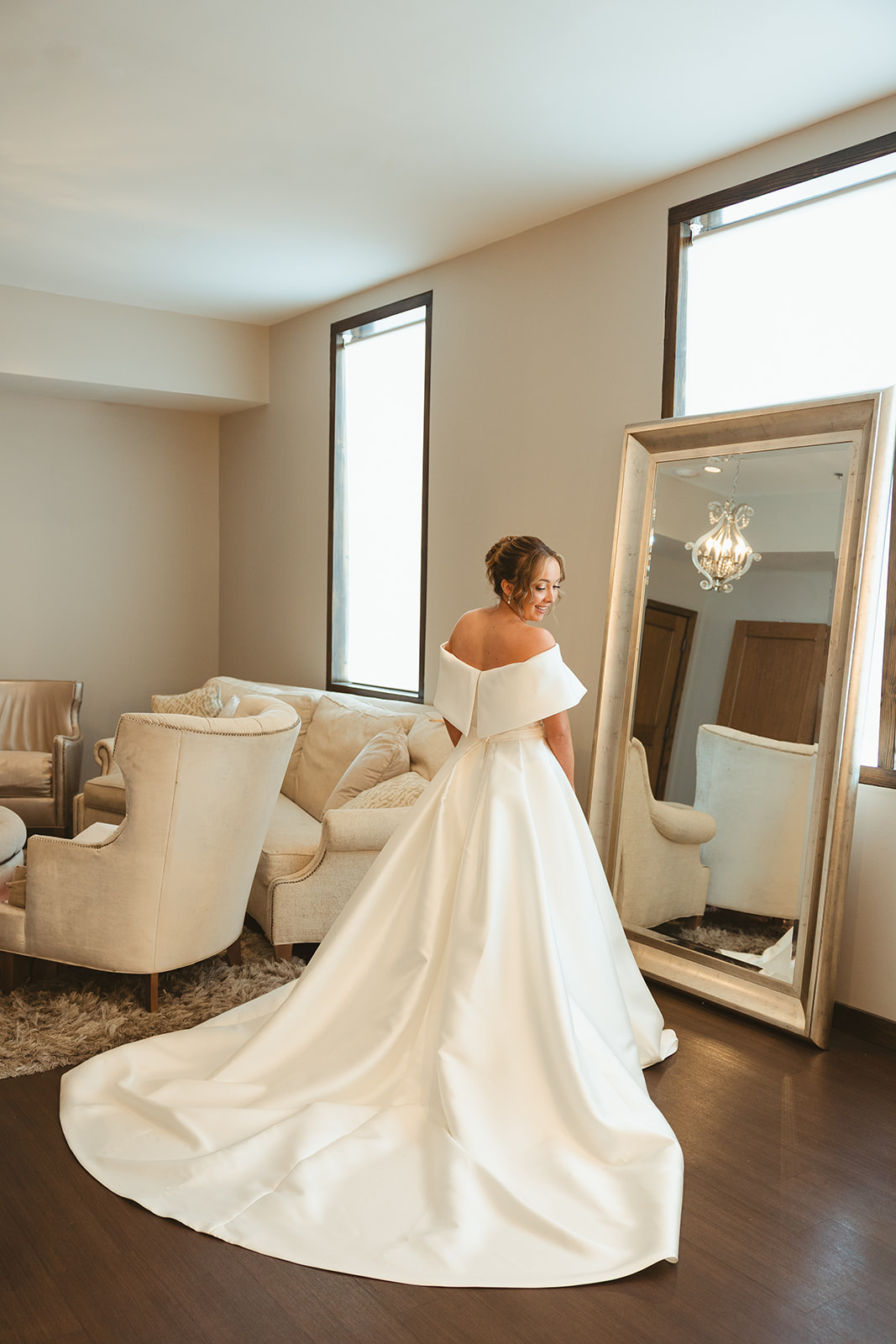 A bride getting in her wedding dress in a wedding bridal suite
