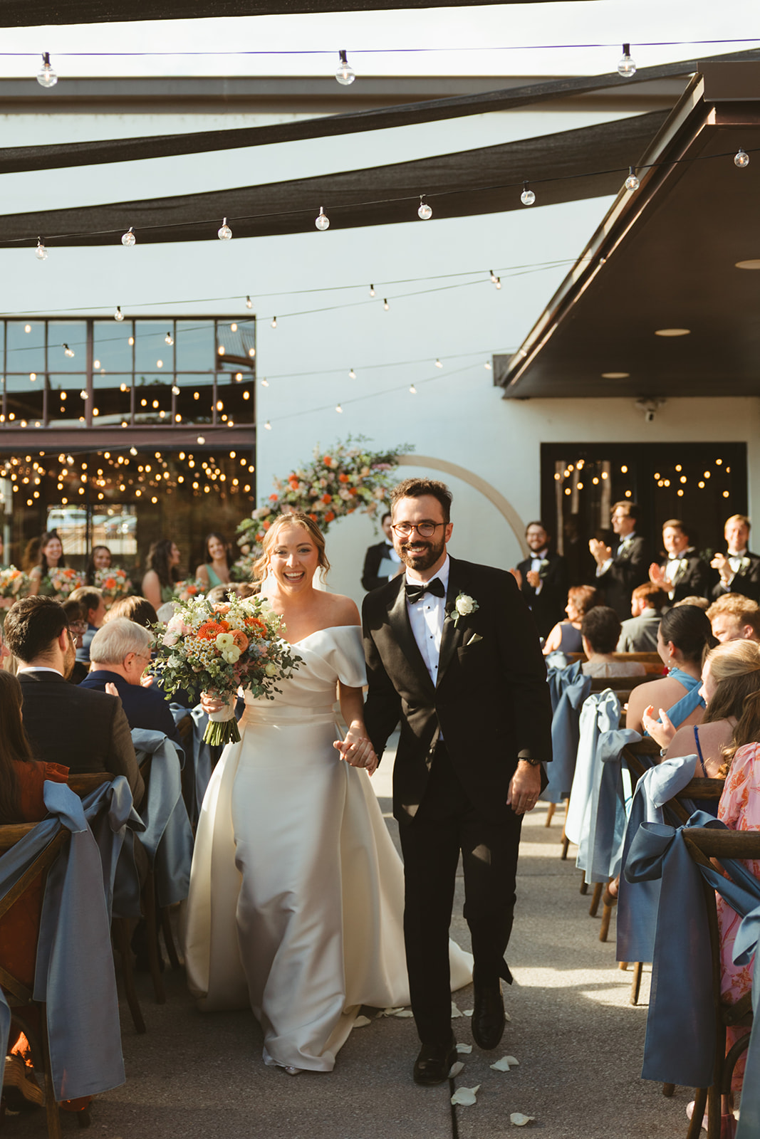 A bride and groom exiting a wedding ceremony captured through documentary style wedding photography