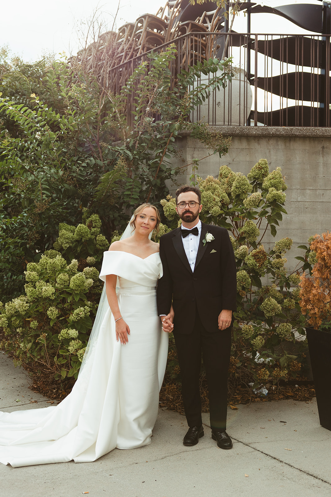 A bride and groom posing for wedding photos