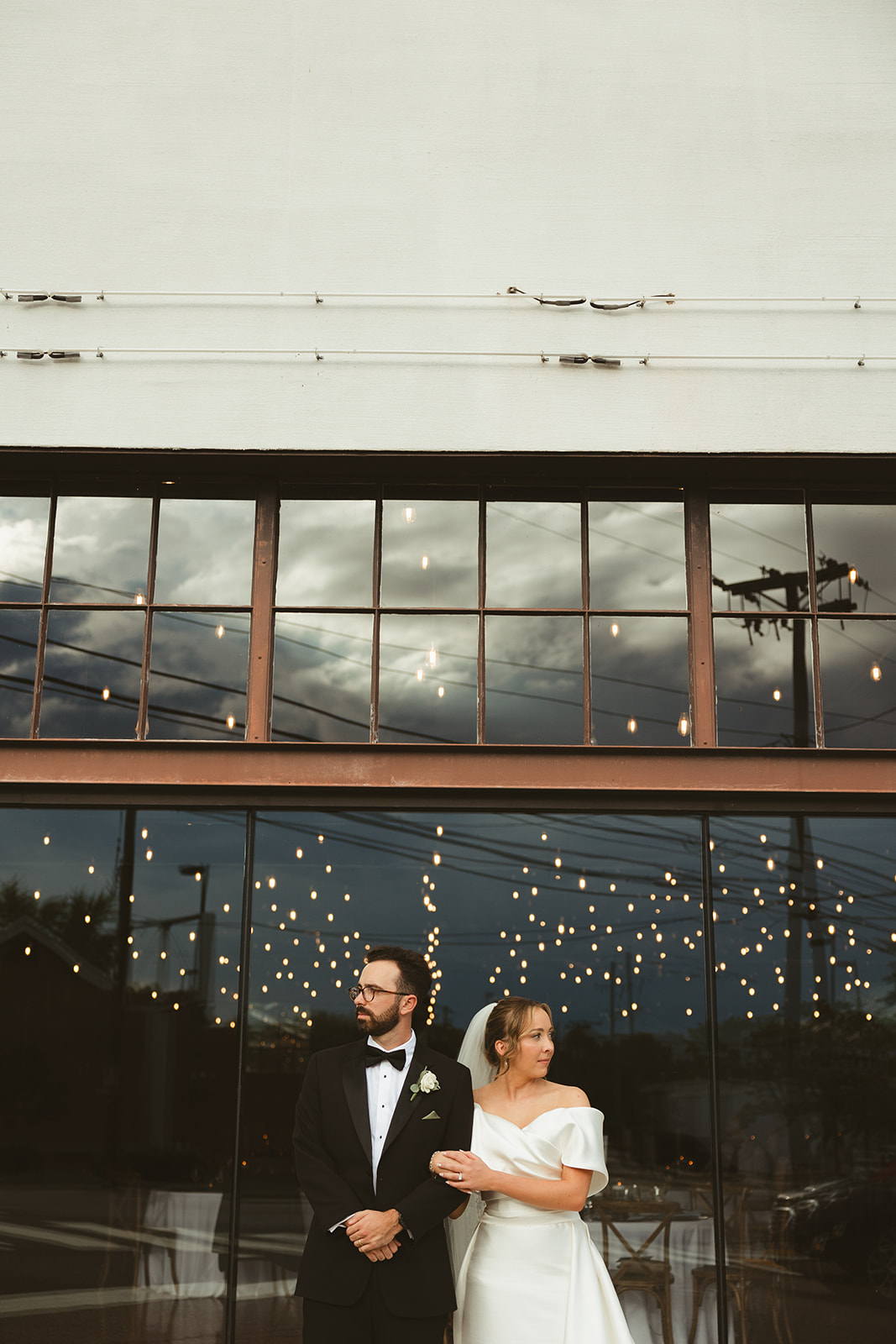 a bride and groom turned away from each other for wedding photos