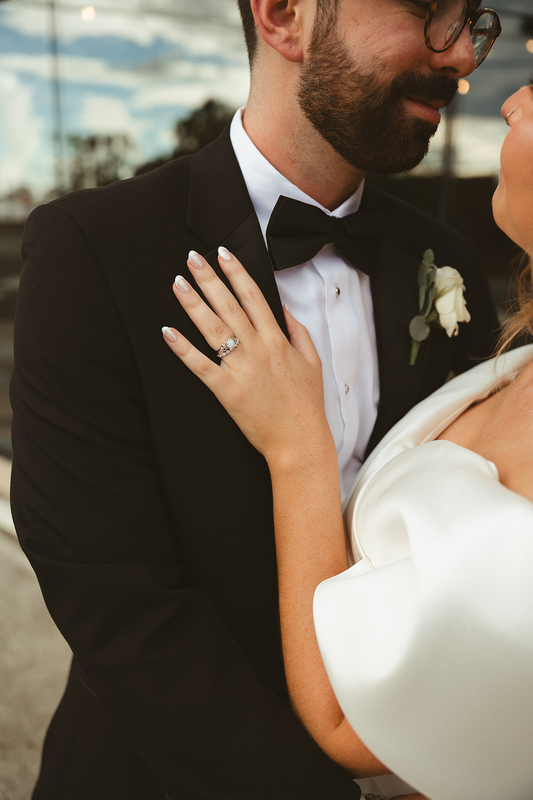An up close photo of a bride and groom hugging