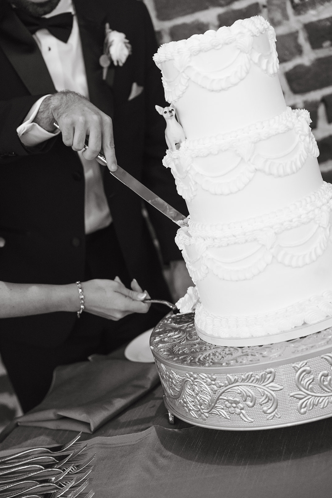 A bride and groom cutting the cake at their wedding reception