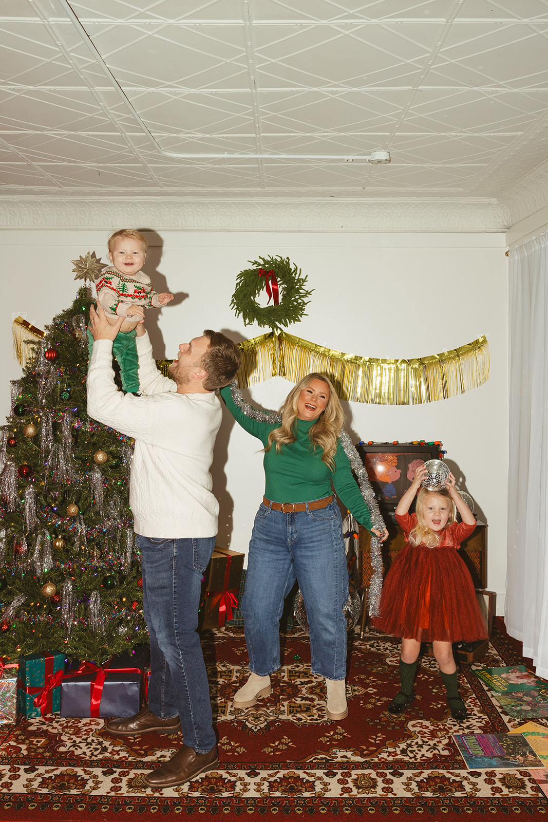A family in front of a christmas tree as christmas photo ideas