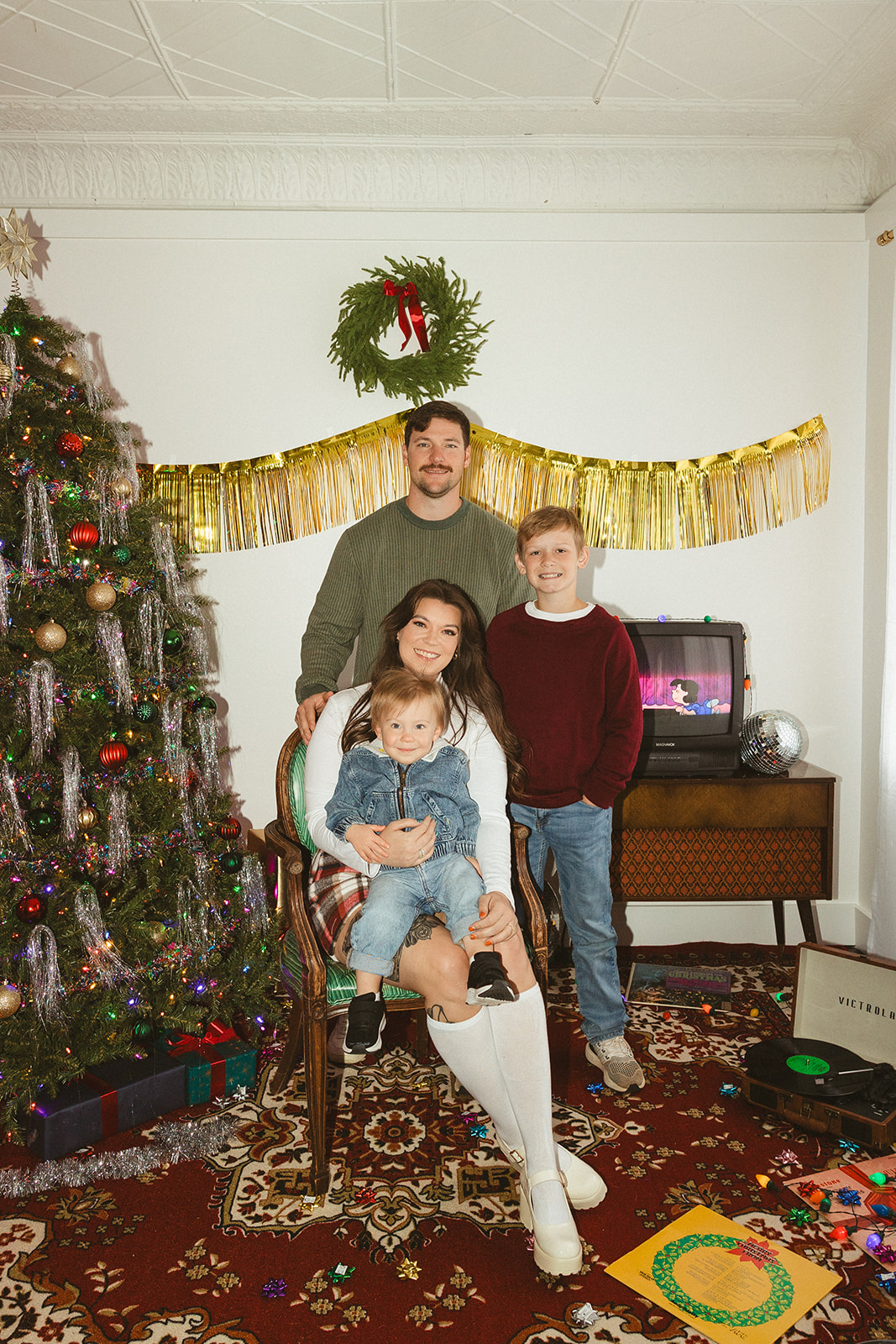 A family sitting around a christmas tree