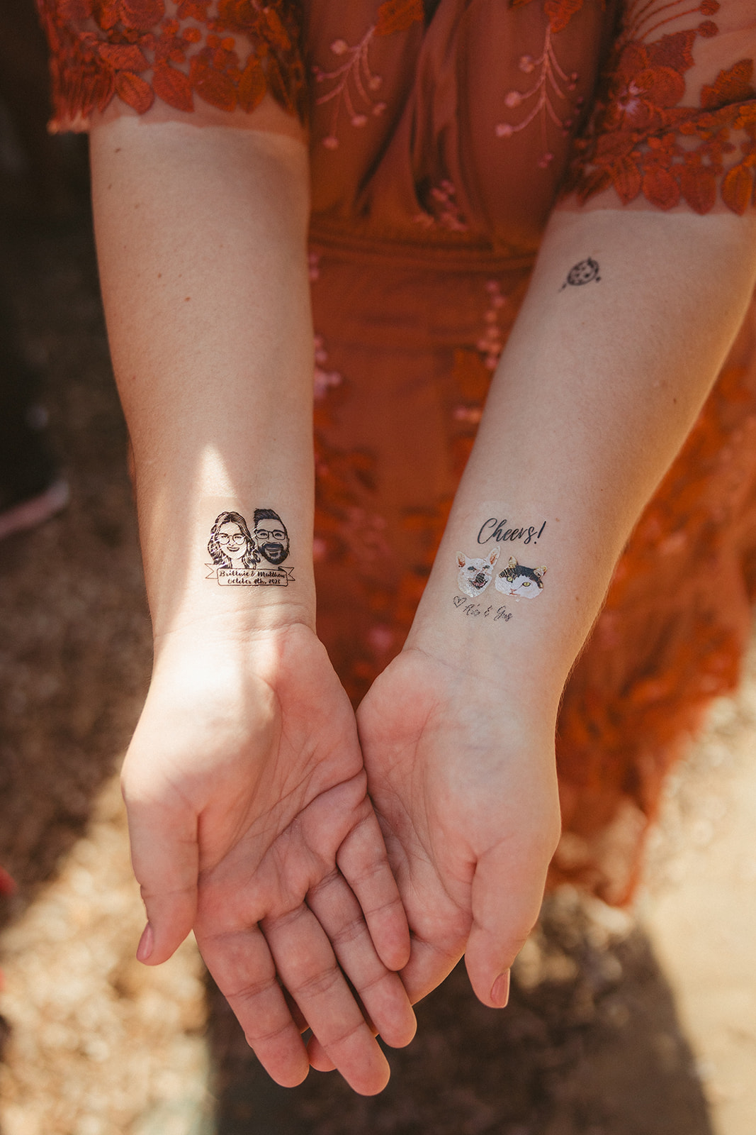 Wedding guests showing off the temporary tattoos they got at a wedding