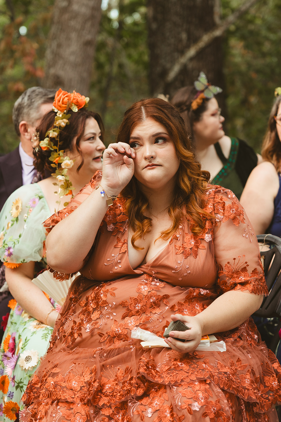A candid photo of a wedding guest crying during the ceremony
