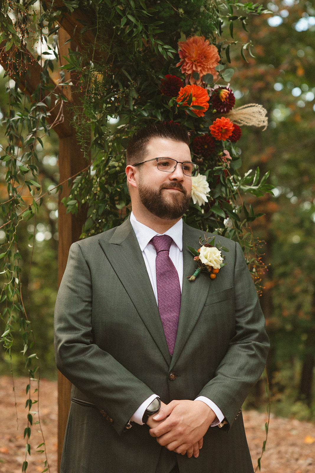A groom watching a bride walking down the aisle at an Ancient Lore Village wedding ceremony