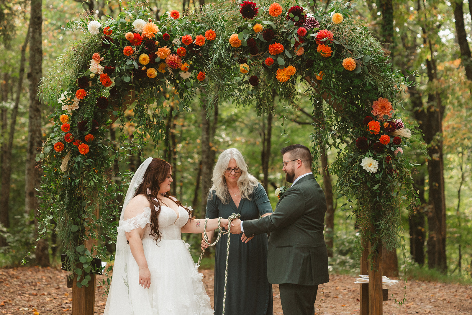 A couple doing a hand fasting ceremony for their wedding
