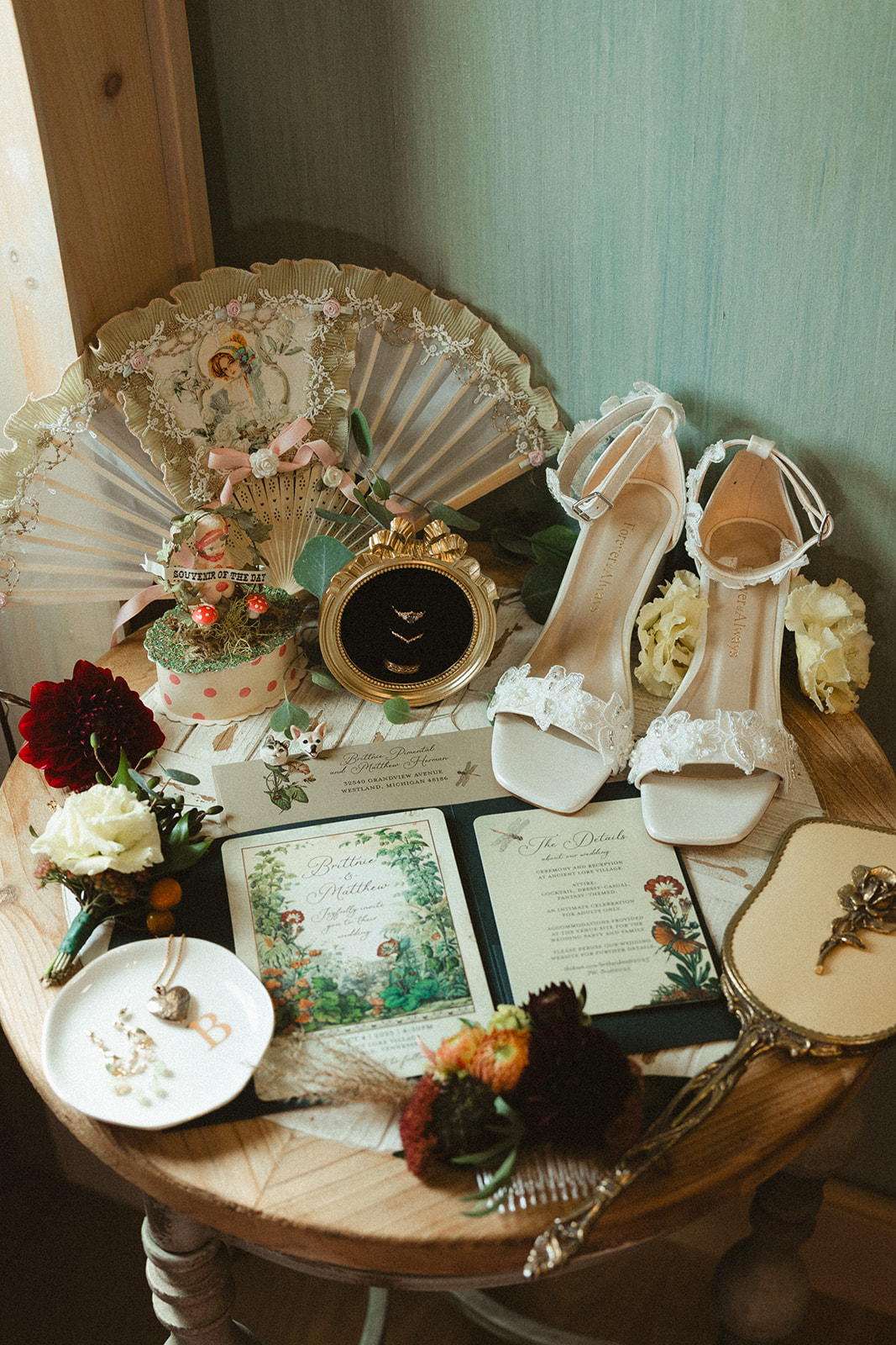 A wedding flat lay with wedding shoes, invitations, and jewelry