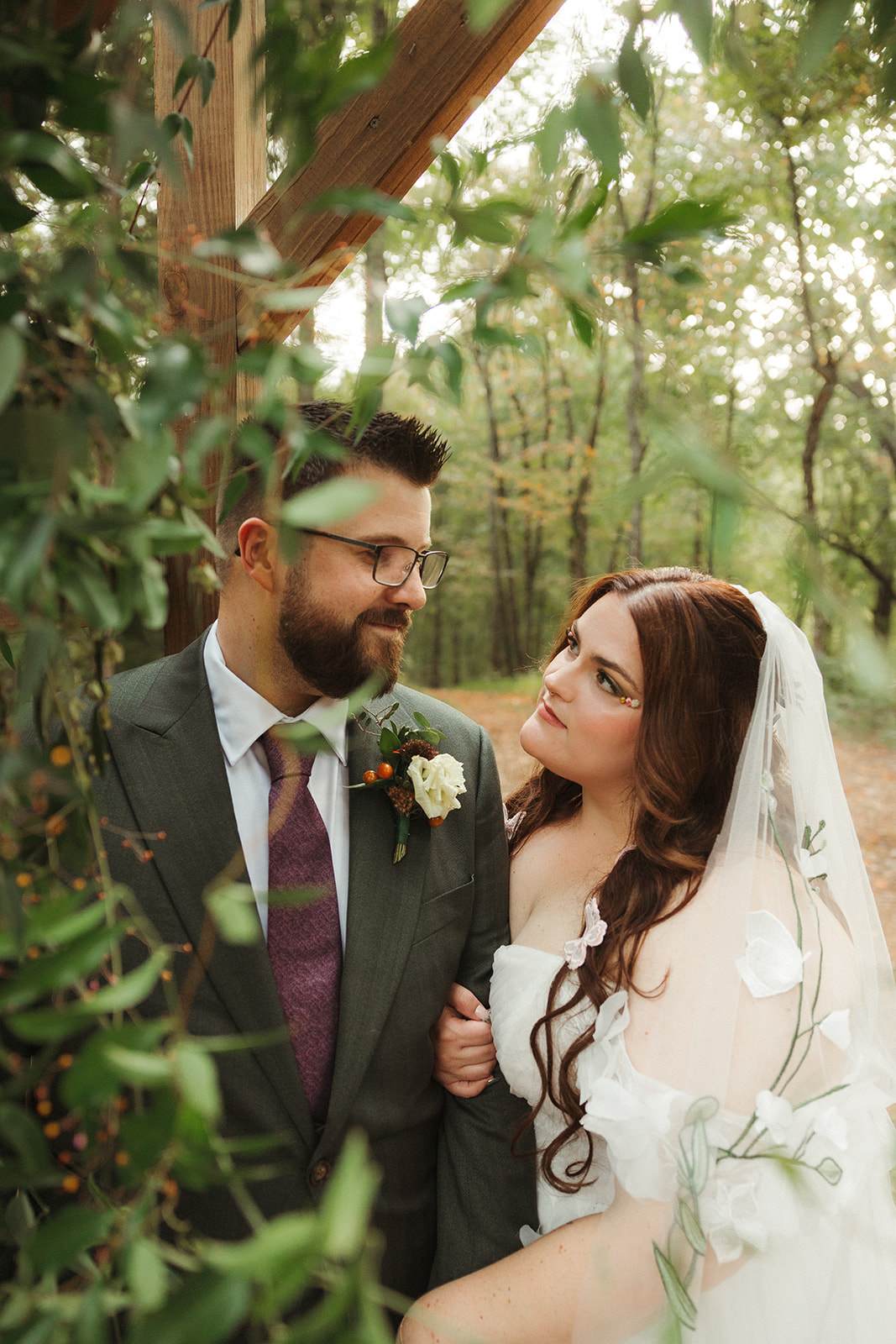 A bride and groom smiling at each other at their renaissance wedding