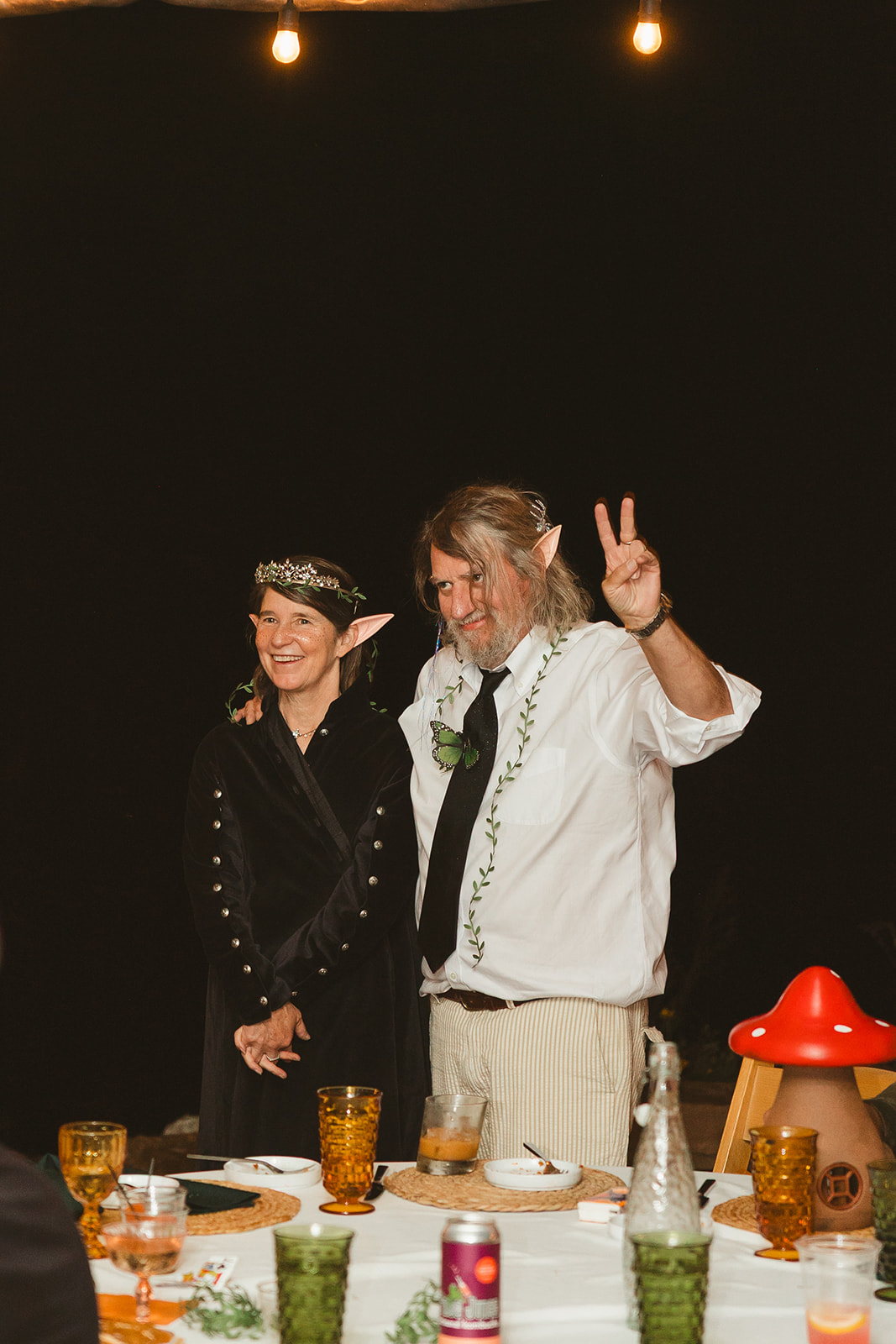 A man and woman at a wedding at Ancient Lore Village with elf ears on