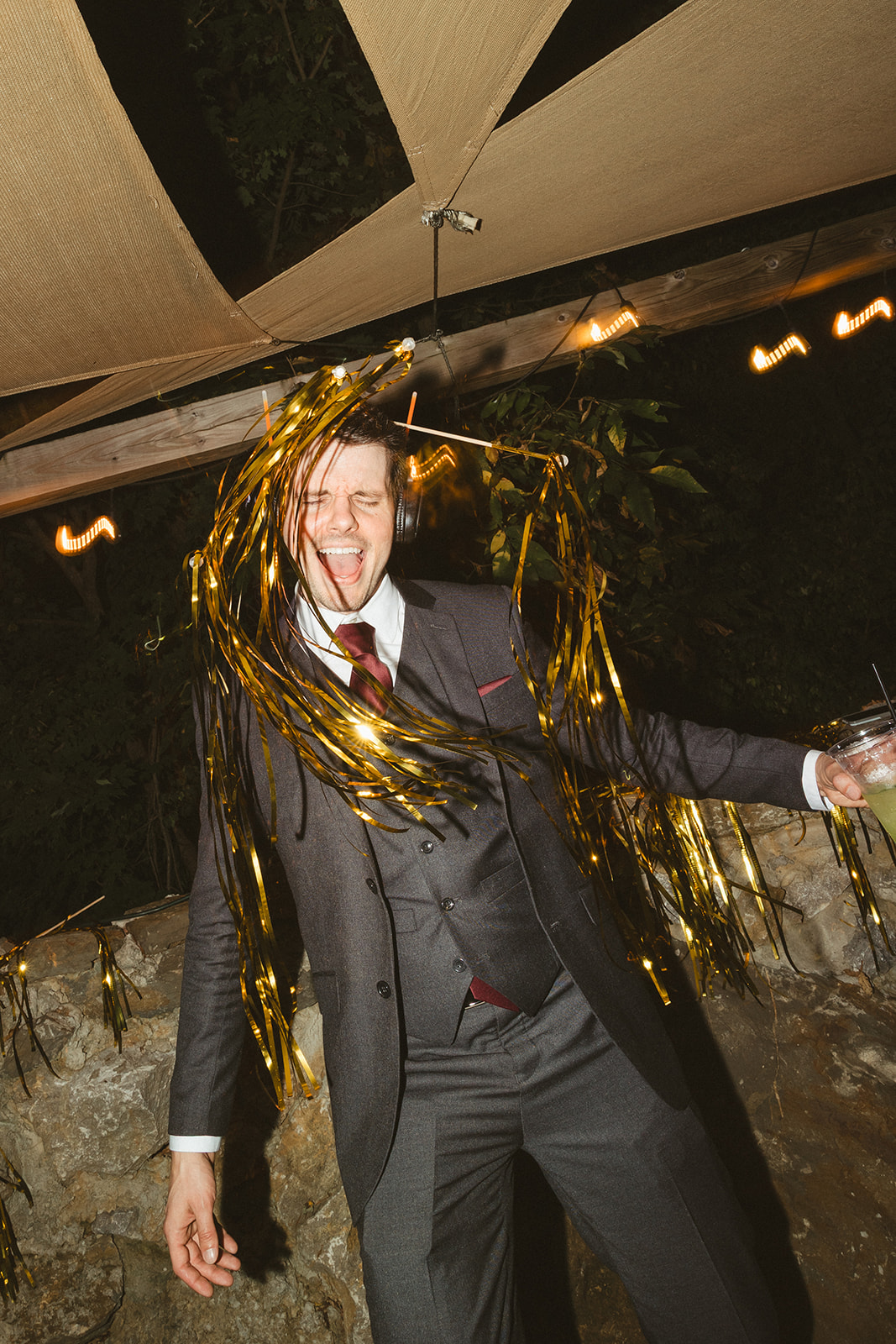 A candid photo of a wedding guest dancing during a silent disco