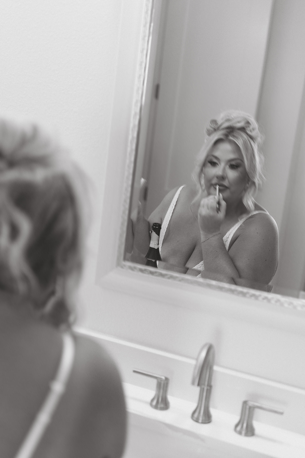 A bride getting ready for her wedding in a black and white photo