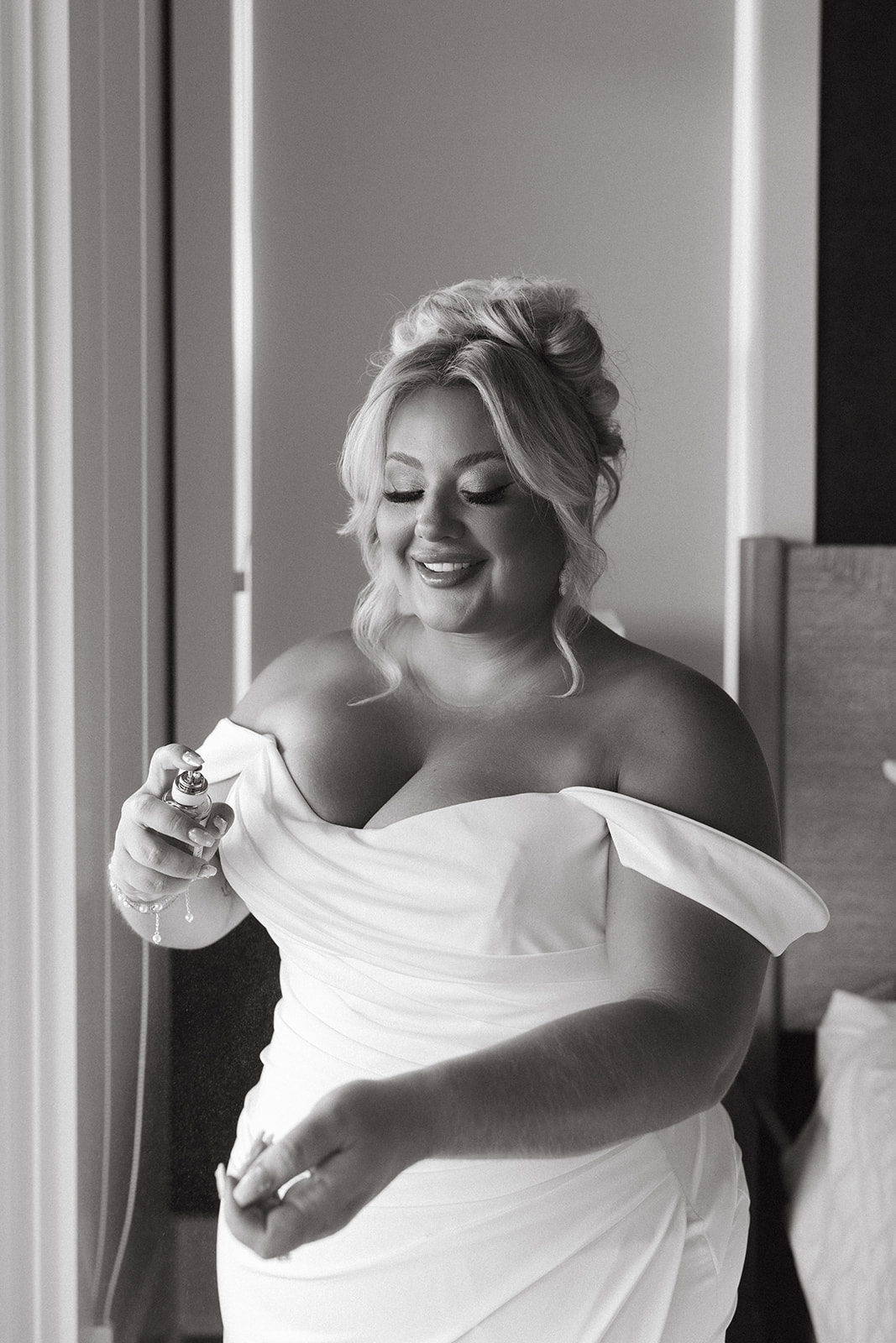 A bride getting ready for her wedding in a black and white photo