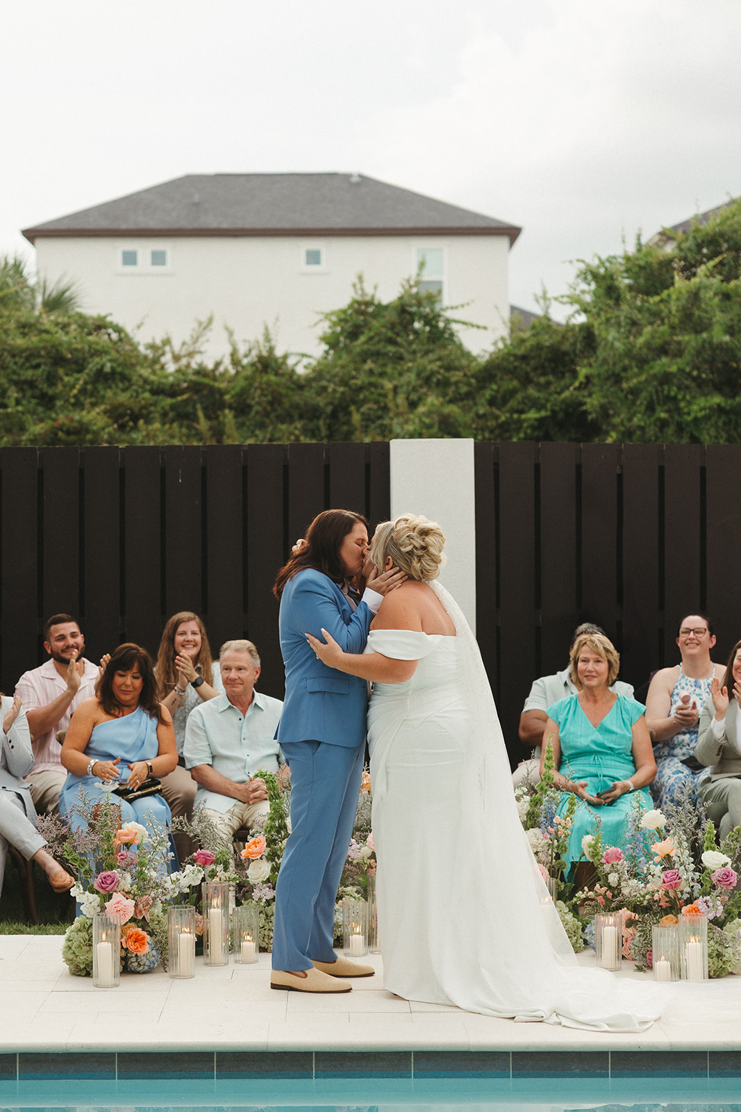 Two brides sharing their first kiss at their wedding ceremony