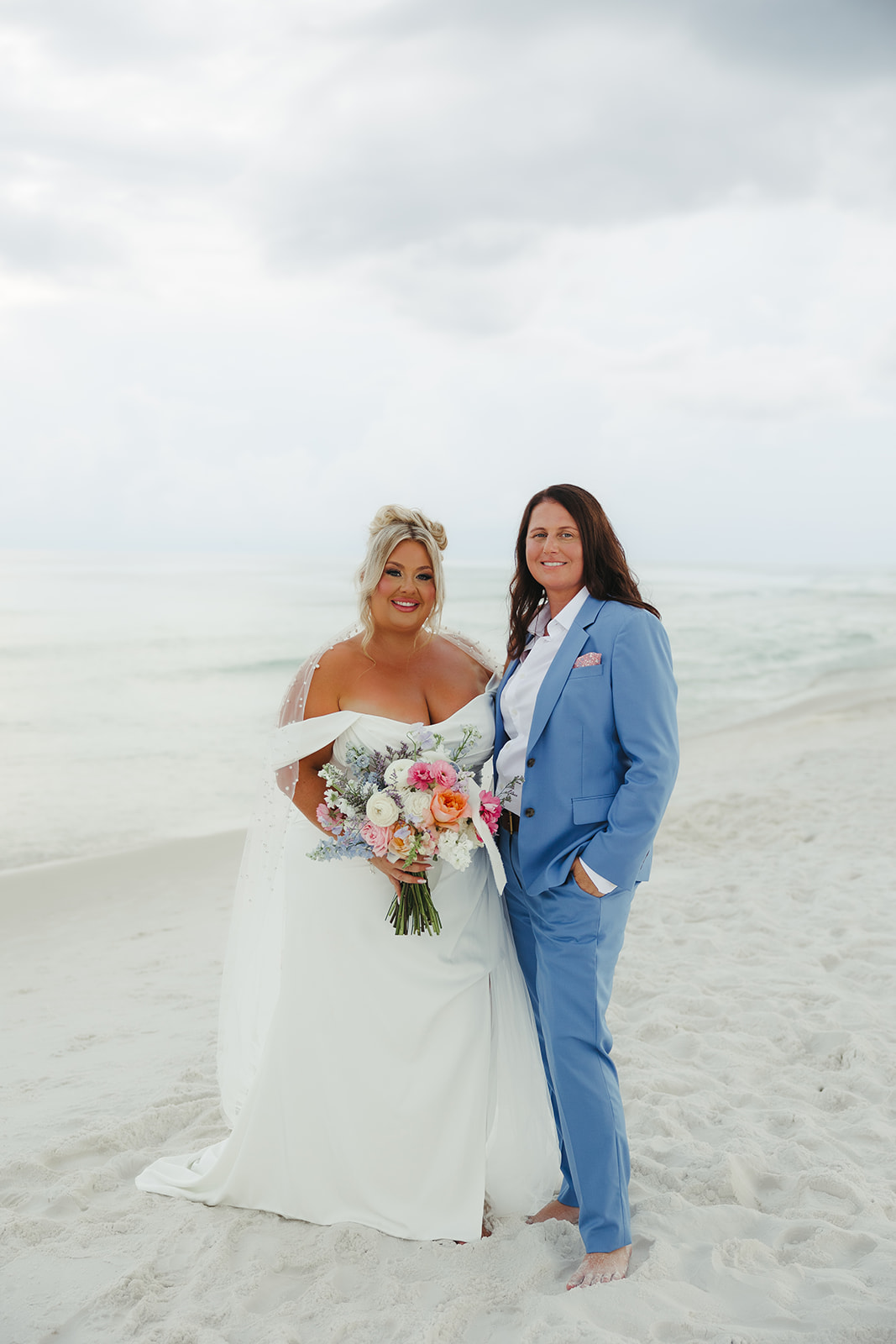 Two brides posing for wedding photos on the beach at a destin beach wedding