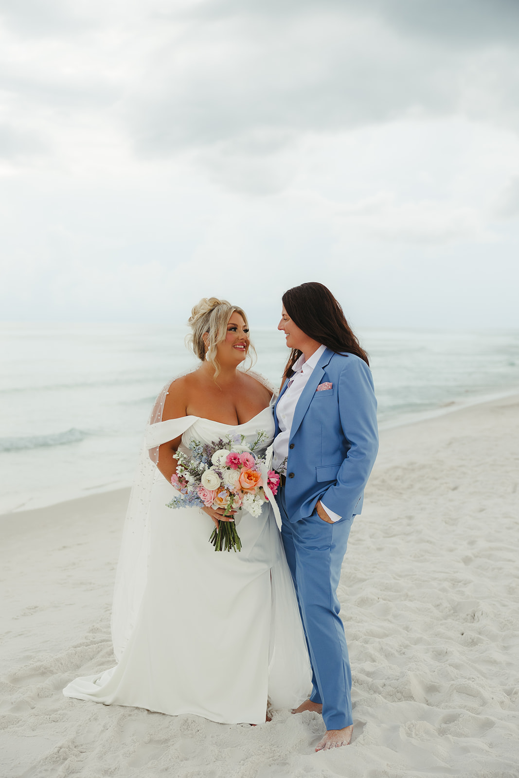 Two brides posing for wedding photos on the beach at a destin beach wedding
