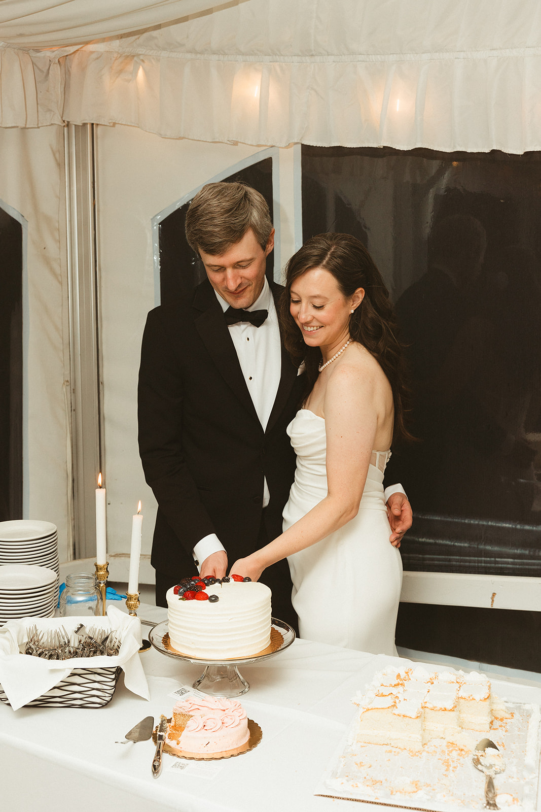A bride and groom cutting their wedding cake