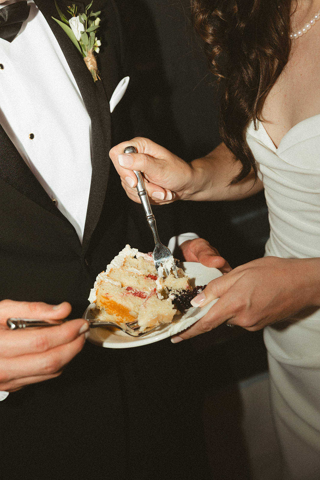 A bride and groom cutting their wedding cake
