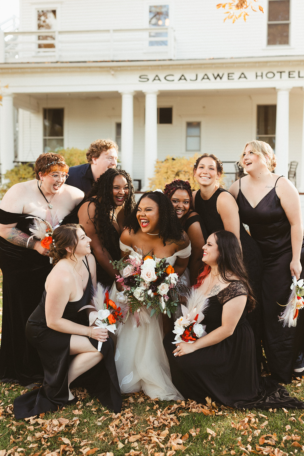 A bridal party posing for photos in front of the sacajawea hotel
