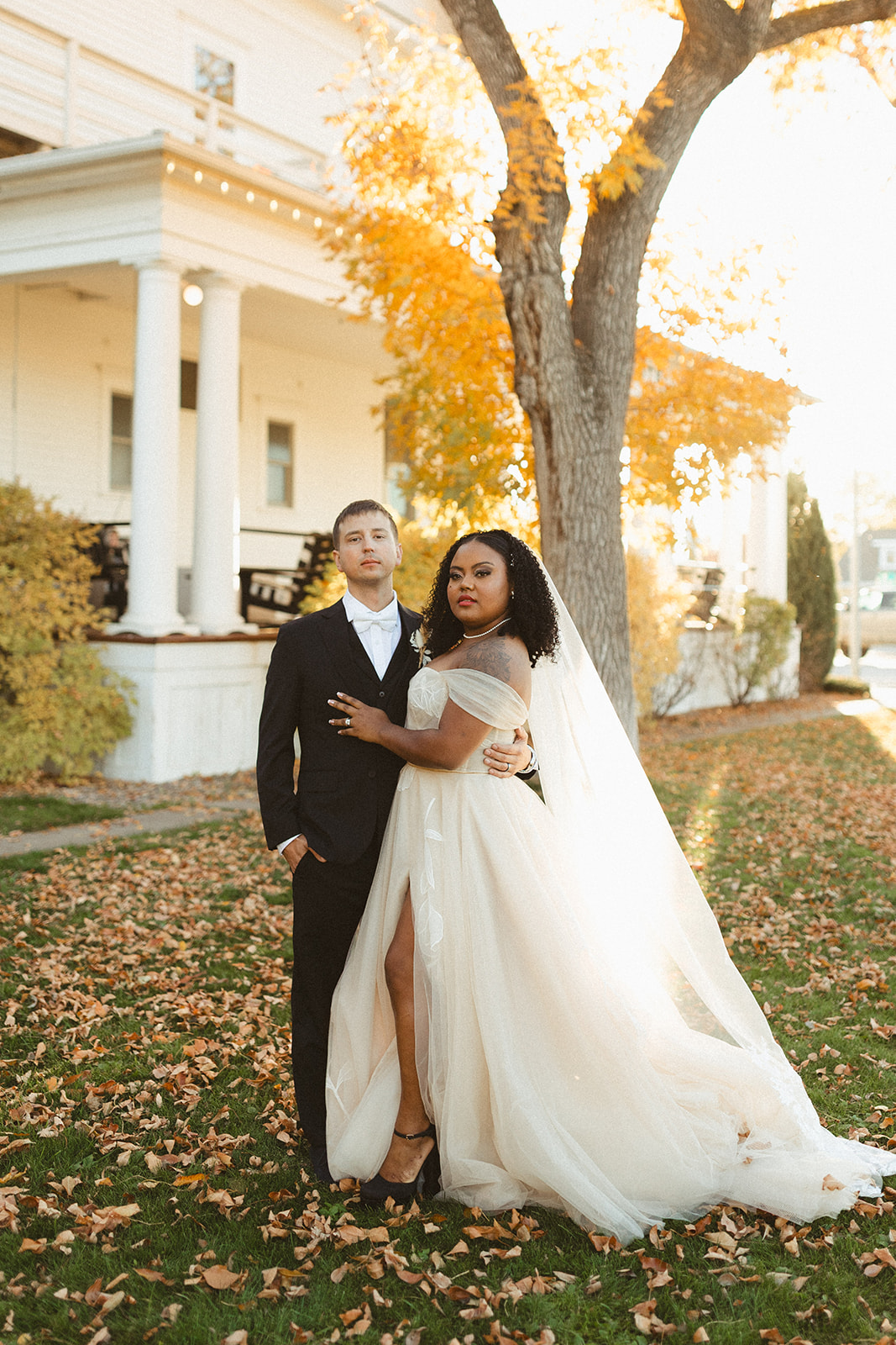 A bride and groom standing in front of the Sacajawea Hotel