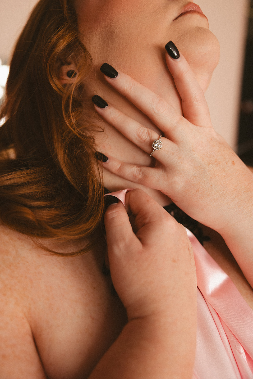 A woman posing for photos during a boudoir session
