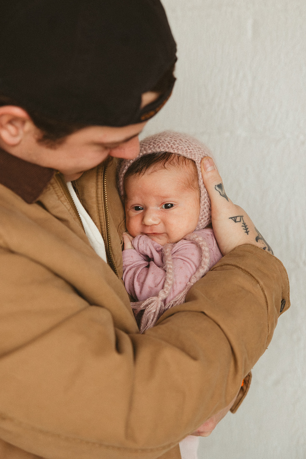 A dad holding a newborn baby
