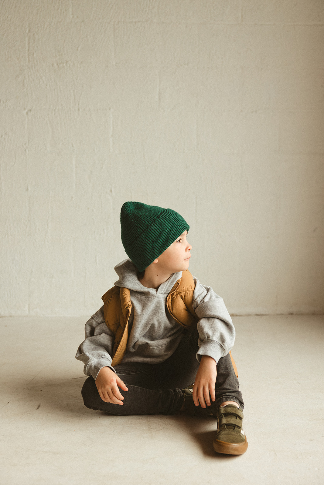 A young boy looking out the window during studio family photos