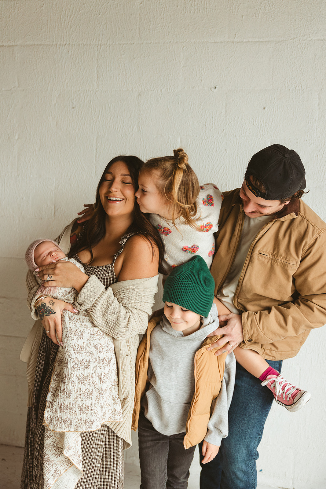 A family laughing during studio family photos