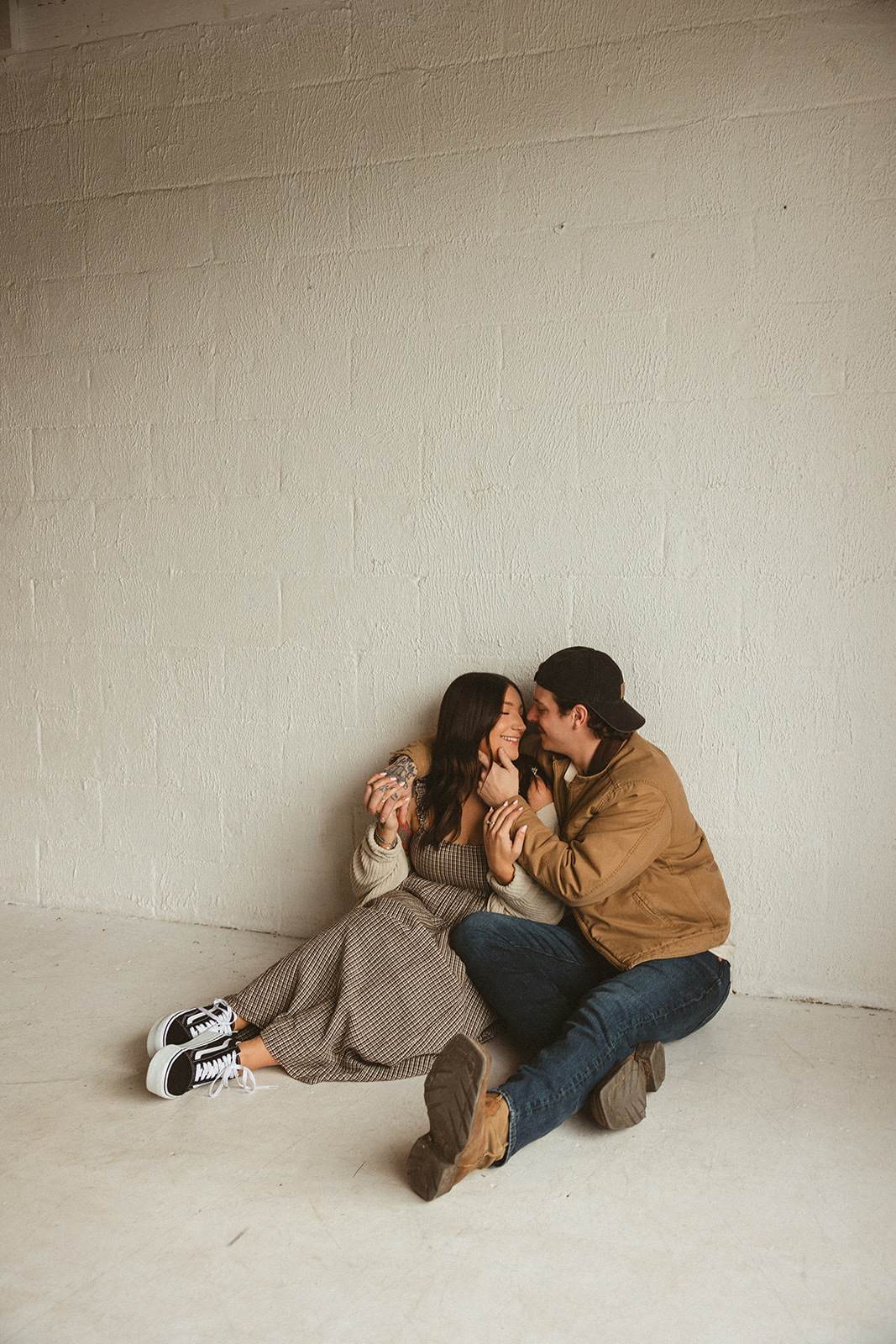 A mom and dad posing for family photos in a studio